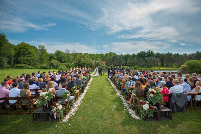 Outdoor wedding ceremony by a pond.