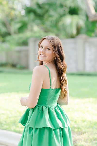 young woman smiling in a green dress
