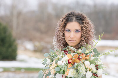 bride with colorful bouquet of winter flowers