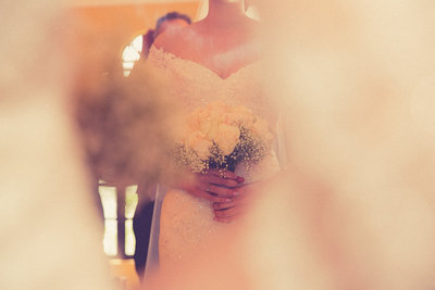 Close up of entwined bride's and groom's hands  behind bridal veil. Photo by Ross Photography, Trinidad, W.I..
