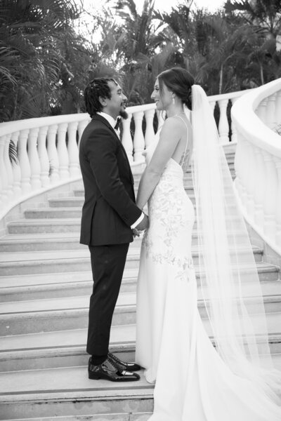 An Austin-based wedding photographer captures a blissful bride and groom standing on a staircase.