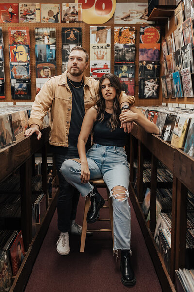 Couple posing for engagement photos in a record store in Philly