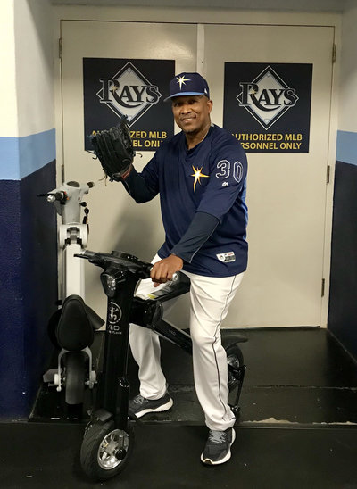 Tampa Bay Rays coach posing on Black Go-Bike M1 with his catcher's mitt