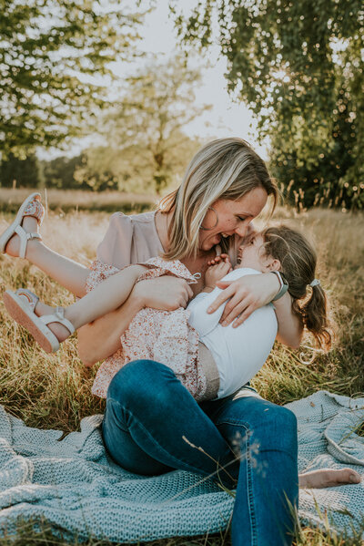 Mother with daughter laughing outside