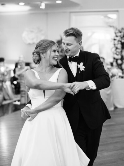 Black and white photo of the bride and groom dancing during their reception at the Longboat Key Club.