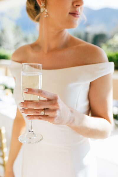 bride holding glass of champagne