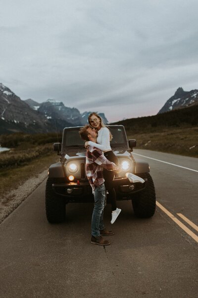 couple posing in front of jeep