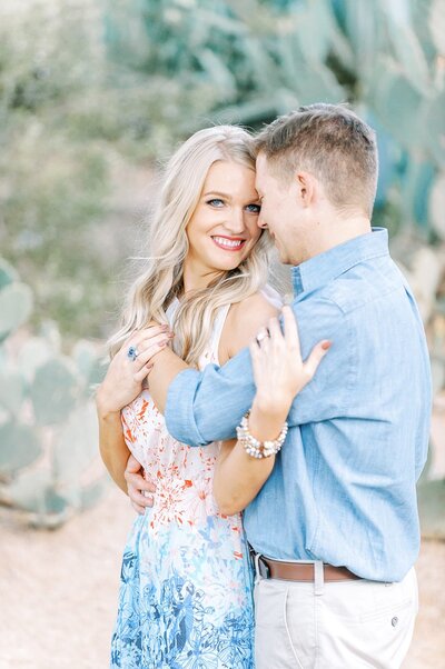 Couple embracing for engagement photos with phoenix wedding photographer