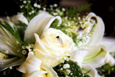 White rose in bridal bouquet with ring. Photo by Ross Photography, Trinidad, W.I..