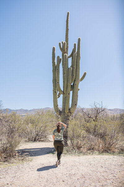 woman standing in front of cactus