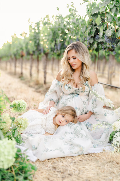 Family of three stands and playfully interacts playfully in a flower field, photography from Bay area photographer Light Livin Photography