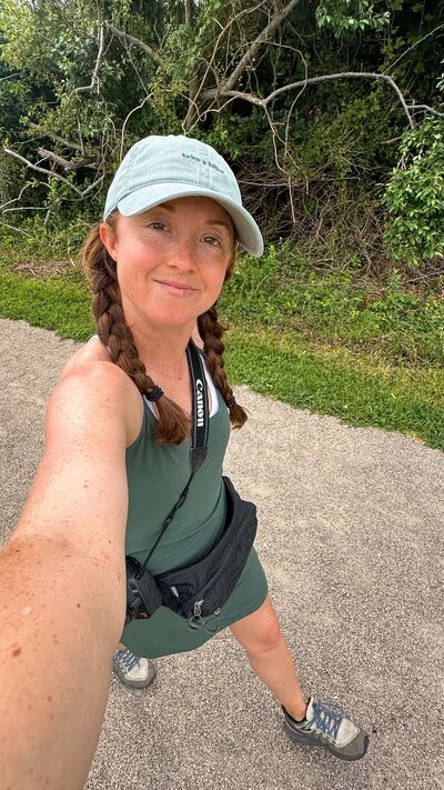 meredith ewenson hiking on a nature trail in rhode island wearing a green exercise dress