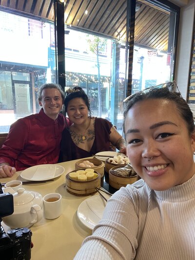 selfie photo of two women and a man at a dimsum restaurant