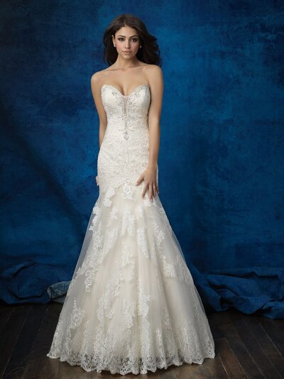 This sleeveless column sheath features sheer illusion netting adorned with bold lace appliques.