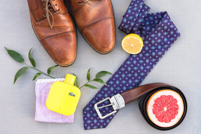 Groom's details with citrus, shoes, and tie.
