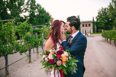 Bride and groom kissing in the vineyards at Casa Rondena Winery in Albuquerque