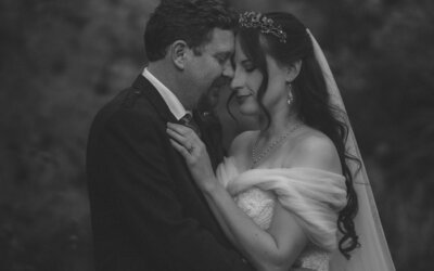 Black and white photo of a couple embracing, capturing a timeless moment of love and intimacy, filled with emotion and connection on their special day