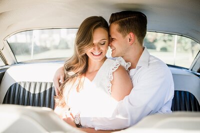 Couple cuddling in car backseat by Knoxville Wedding Photographer Amanda May Photos