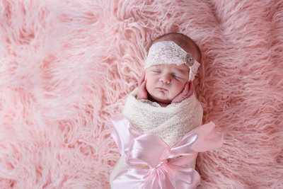 Beautiful Mississippi Newborn Photography:newborn girl wrapped in ivory, pink and pearls