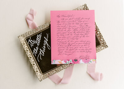 A hand written love note from a groom is displayed on a decorative tray.
