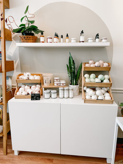facial products on white wall shelf