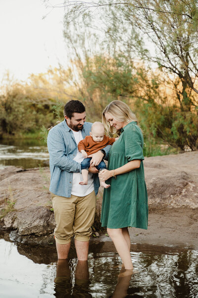 mom and dad play with their child  and explore at the salt river