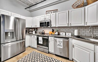 Kitchen with stainless steel appliances in this studio vacation rental condo in the historic Behrens building with a 5th floor view of downtown Waco, TX