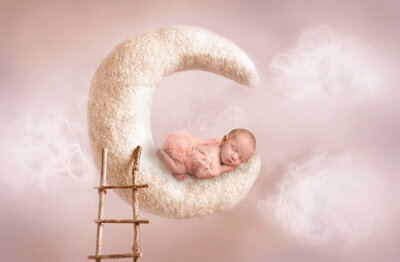 newborn baby laying on a moon by Elsie Rose Photography