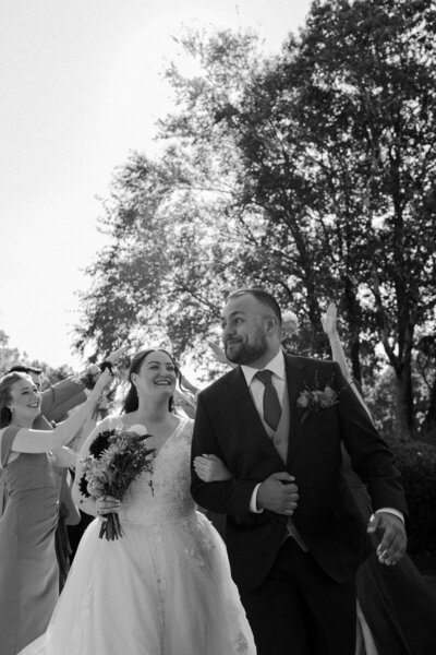 a New England couple that just got married walking down the aisle