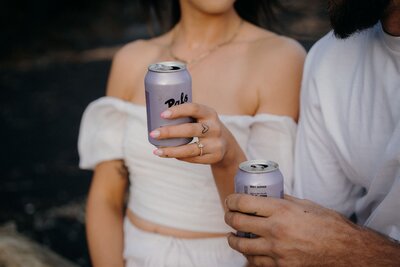 A close up of a couple holding pals during their engagement photoshoot with Tashina Narelle Photography