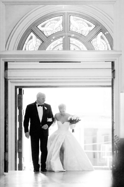bride and her dad walking up the steps into church in Manhattan, New York City
