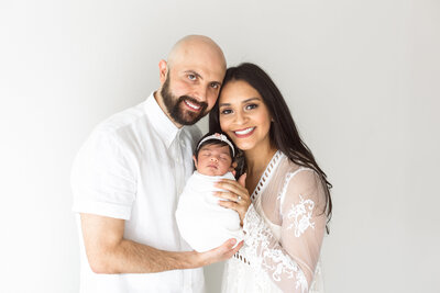 parents smiling with baby