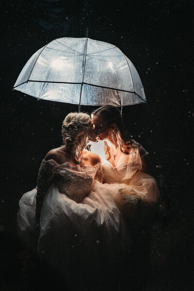 Brides Kiss under umbrella rain at night in Cuyahoga Valley National Park