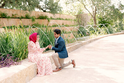 Austin Proposal Photographer capturing a proposal by lush greenery and water fountains