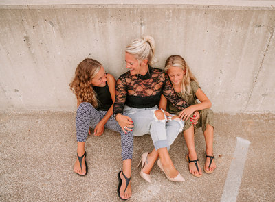 mom and two daughters laughing