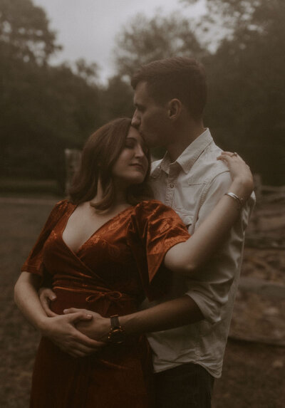 a couple embracing for their romantic engagement photos