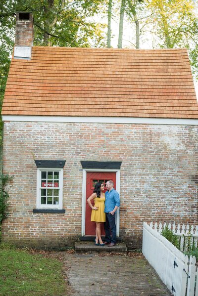 Engagement portrait in front of cute cottage