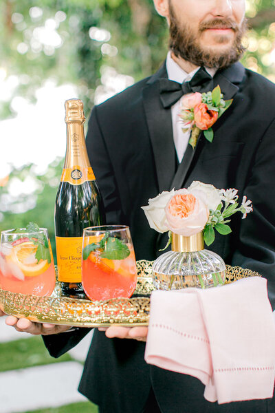 bartender holding a tray with champagne and drinks