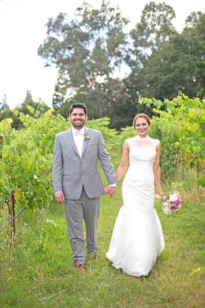 bride and groom walk down vineyard aisle in los angeles wedding as halley lutz captures their photos