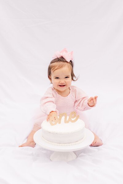 little girl smashing a cake on her first birthday in Murfreesboro, TN