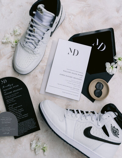 Mal and Dansby's black and white wedding invitations and custom Nike's.
