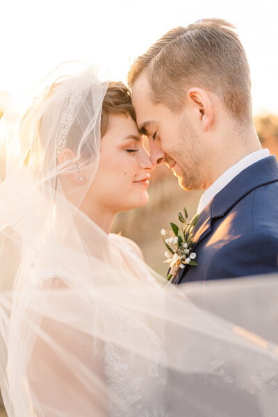 Bride and groom standing forehead to forehead at sunset taken b y los angeles wedding photographer rachel