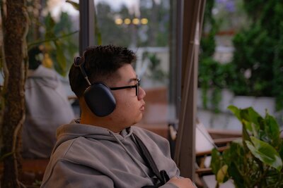 Man using over-ear headphones for nervous system therapy in a calming environment