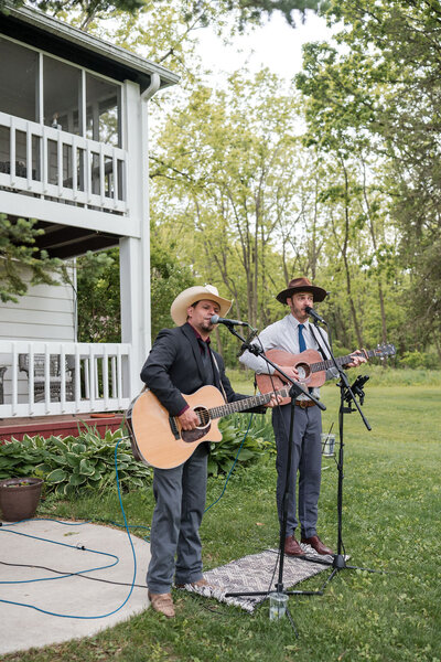 musicians playing guitar outside the barn house at barnwood events in madison, winconsin.