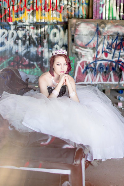 Teenager in Prom Dress and Crown posing on couch