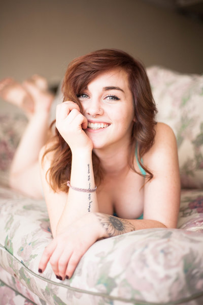 A redhead woman during a boudoir photoshoot.