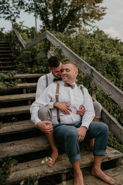 grooms holding each other