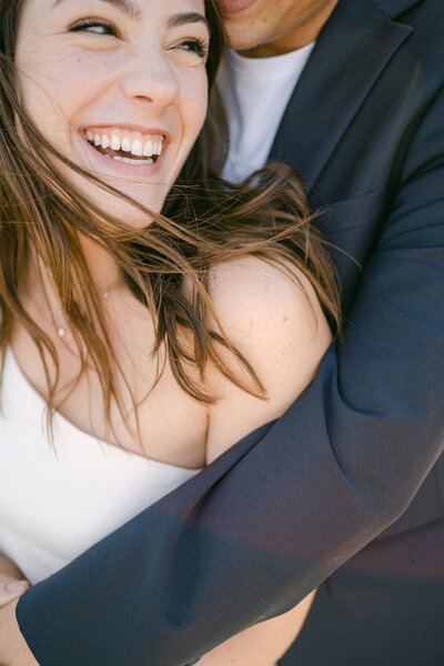 Groom snuggled up to his bride making her laugh