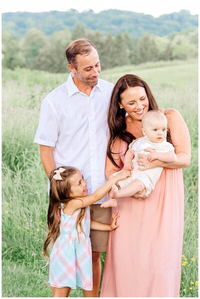 Mom, Dad, big sister are looking at baby boy.  Pittsburgh PA Family Photographer