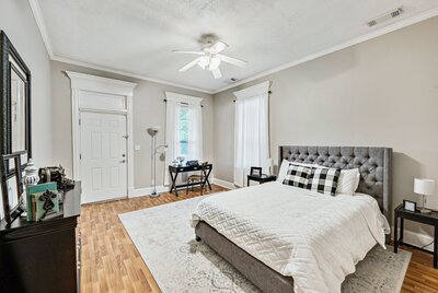One of the upstairs bedroom with door to the porch in historic vacation rental home in downtown Waco, TX